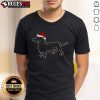 Cute Dachshund dog wearing a Santa hat under Christmas lights, perfect for festive Dachshund Christmas T-shirts.