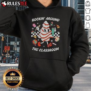 Teacher in a cute Rockin' Around The Classroom hoodie, smiling and engaging with students in a vibrant classroom setting.