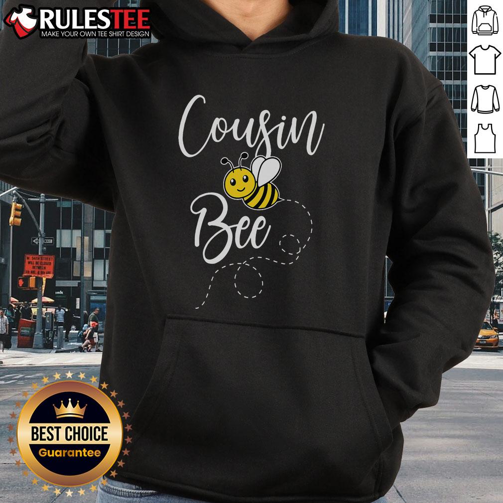 Cute cousin of the bee day girl wearing a matching birthday hoodie with hive family theme, celebrating together.