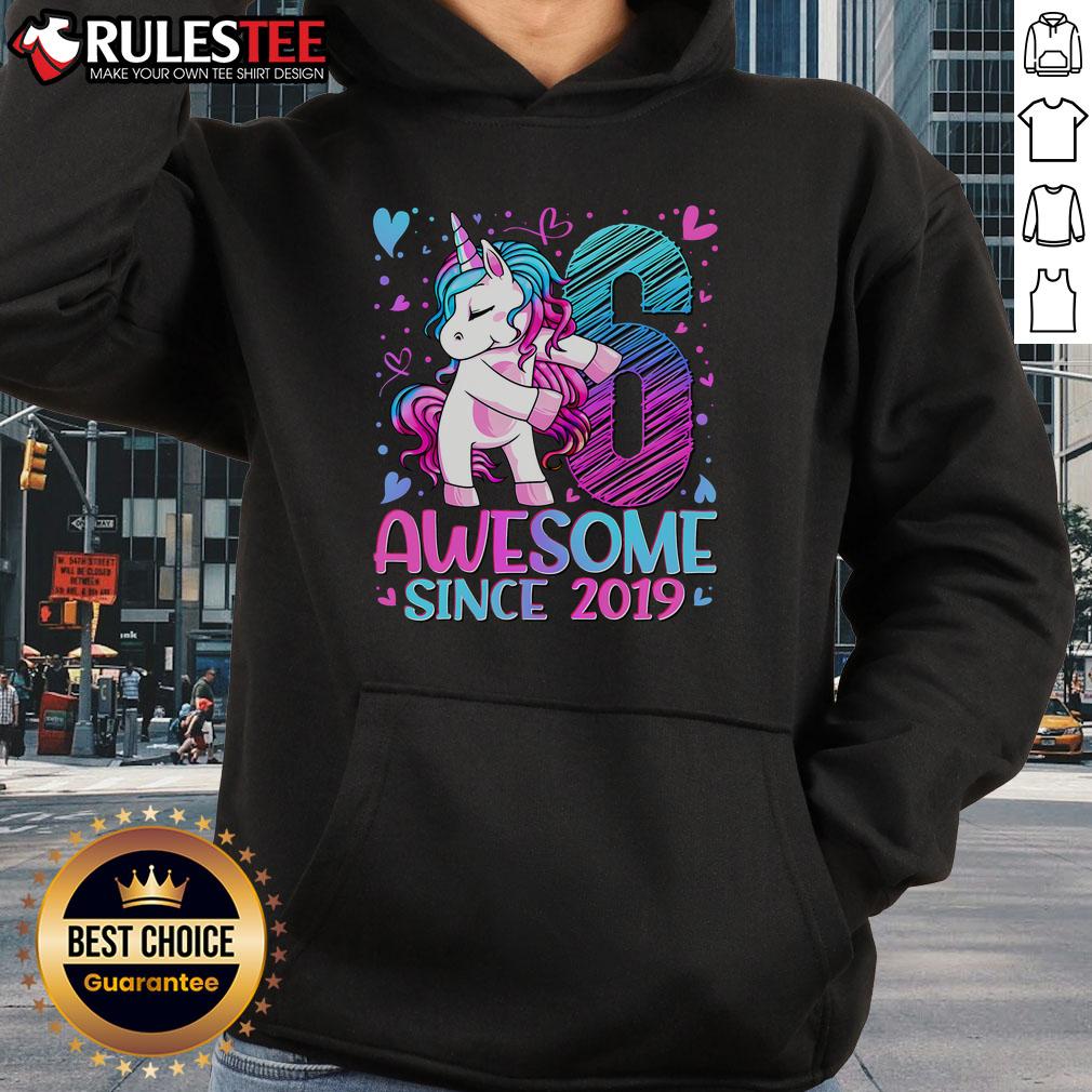 Cute 6-year-old wearing a 'Awesome Since 2019' unicorn hoodie, smiling and playing outdoors.