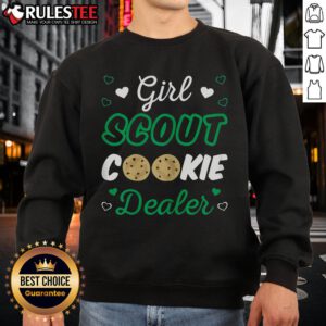 Adorable girl in a Girl Scout Cookie Dealer sweatshirt, smiling and showcasing her cookie sales with a cheerful vibe.