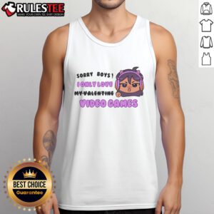 Girl wearing a 'Sorry Boys, I Only Love Video Games' cat ears tank top with headphones, smiling in a cozy gaming setup.