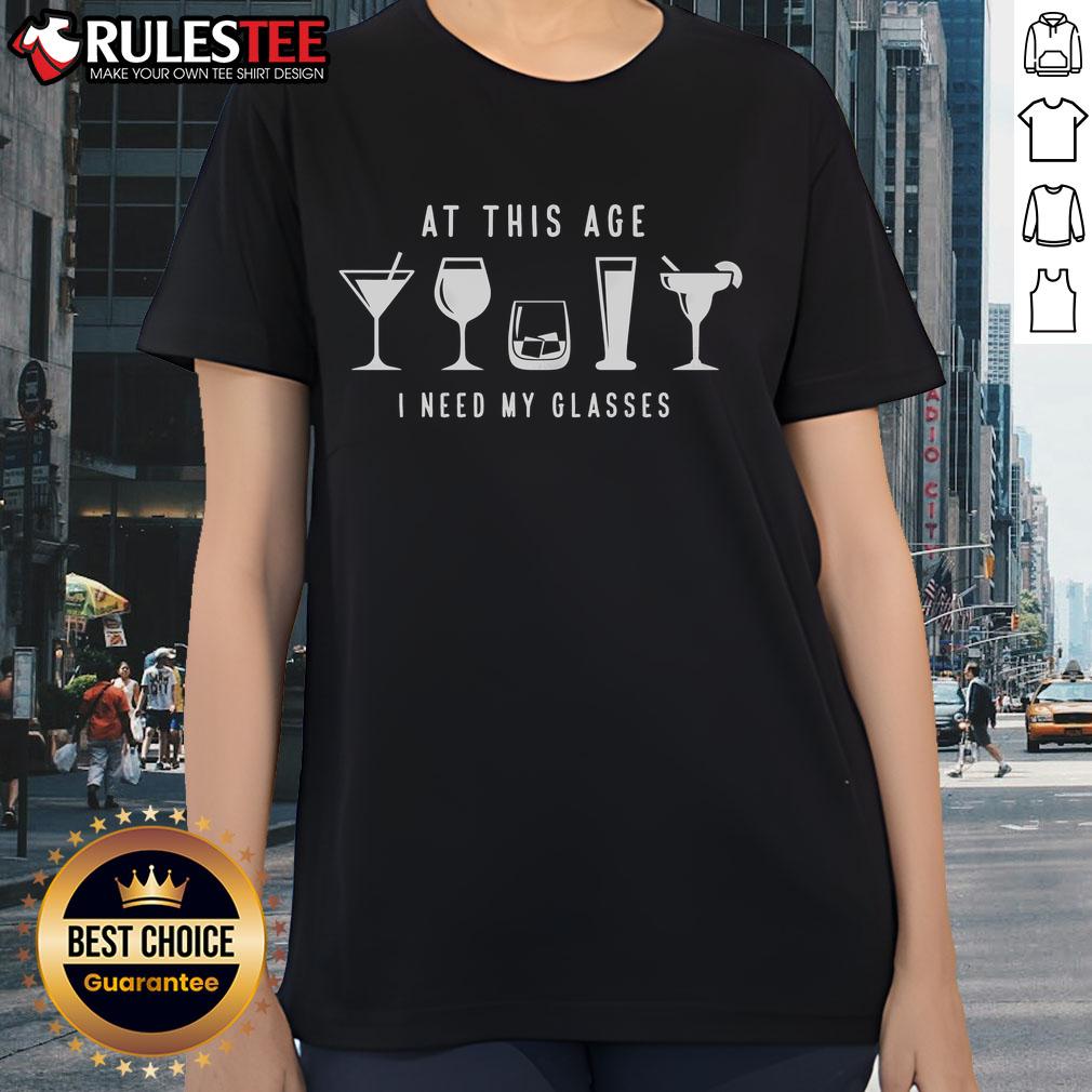 Funny 'At This Age I Need My Glasses' drink ladies tee featuring humorous text and playful design for casual wear.