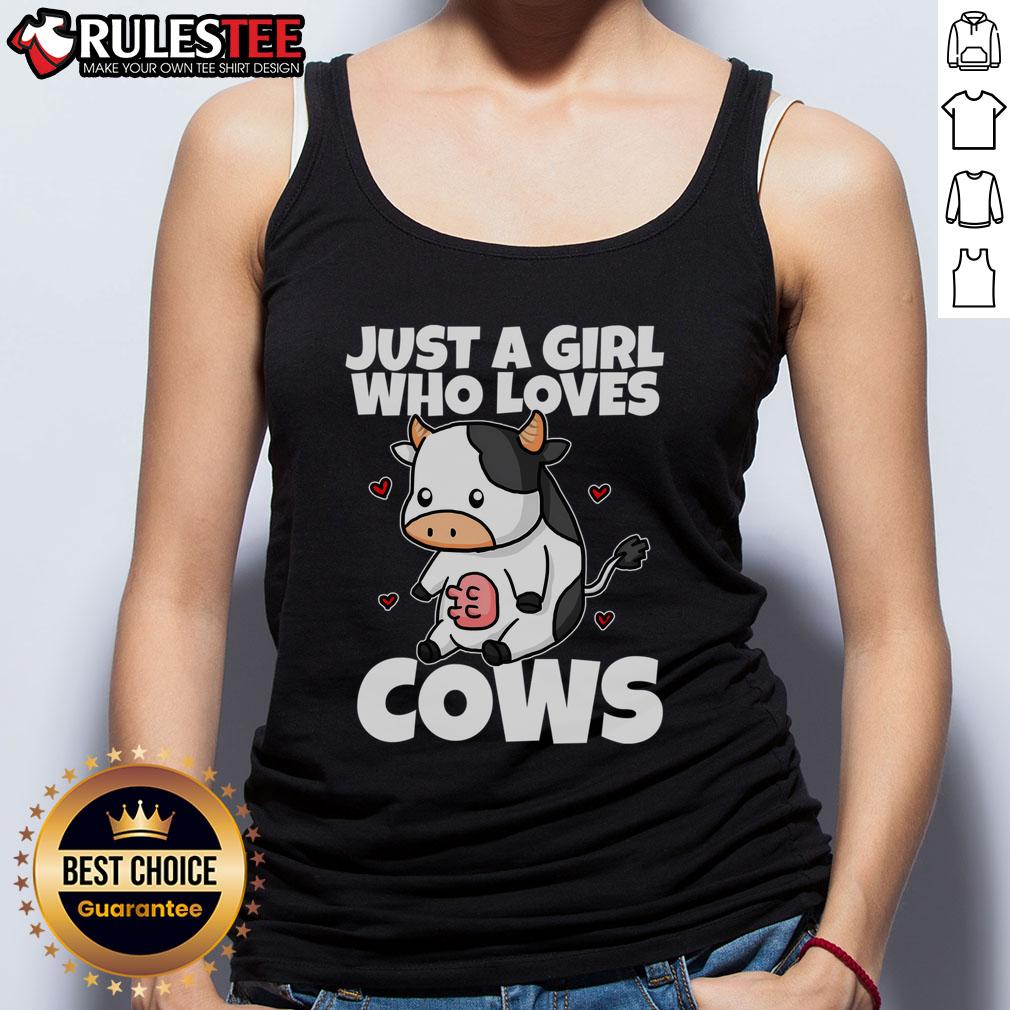 Alt Text: Cute girl wearing a 'Just A Girl Who Loves Cow' tank top, holding a glass of fresh cow milk on a farm.