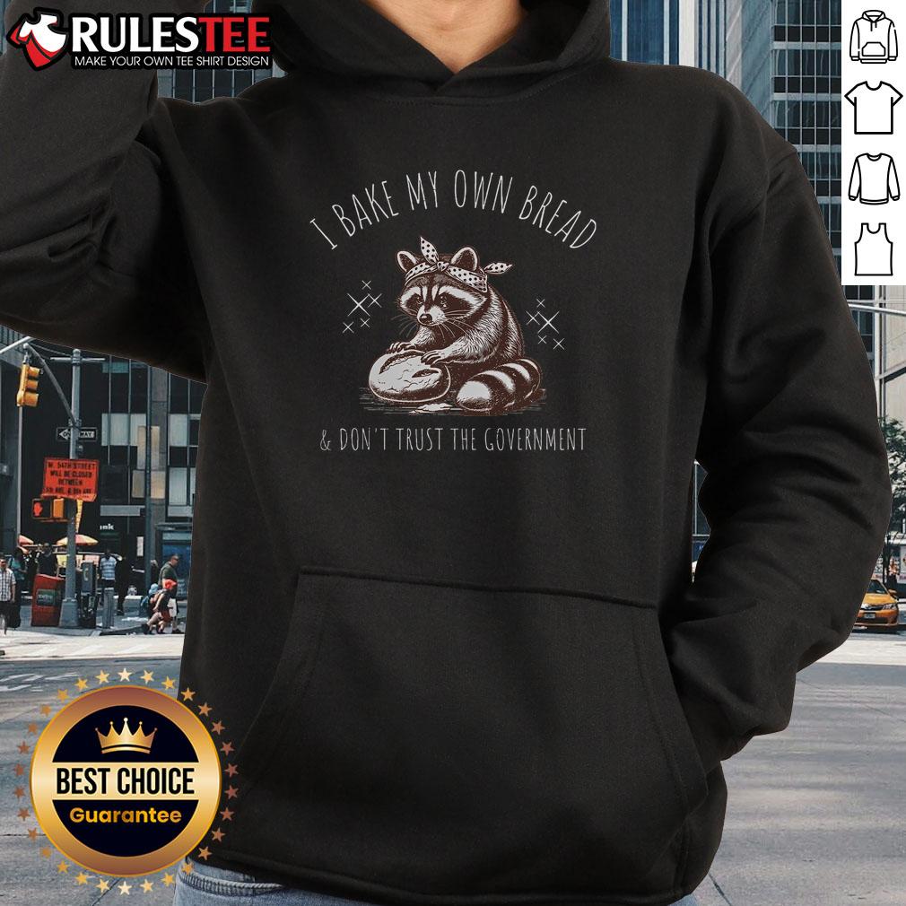 Raccoon hoodie with 'I Bake My Own Bread and Don't Trust the Government' slogan, perfect for quirky fashion lovers.