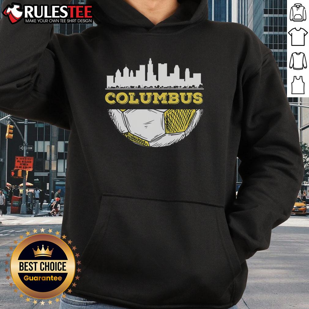 Alt Text: Awesome Columbus skyline view featuring a soccer lover wearing a Columbus hoodie in a vibrant urban setting.