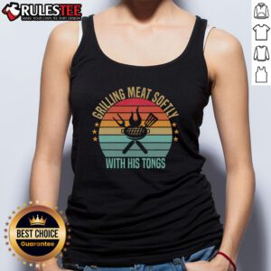 Man grilling meat with tongs in a vintage barbecue tank top, showcasing a delicious outdoor cooking experience.