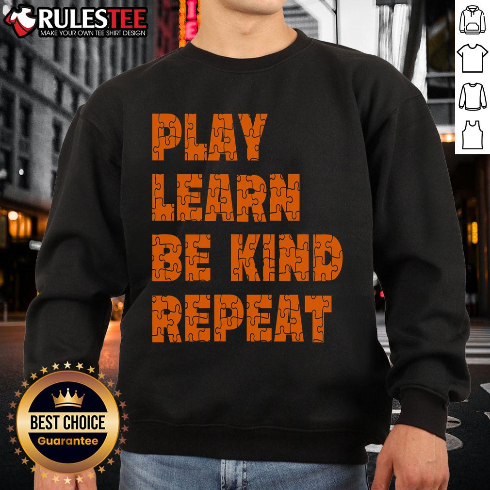 Orange sweatshirt with 'Play, Learn, Be Kind, Repeat' for Autism Awareness Unity Day, promoting kindness and inclusion.