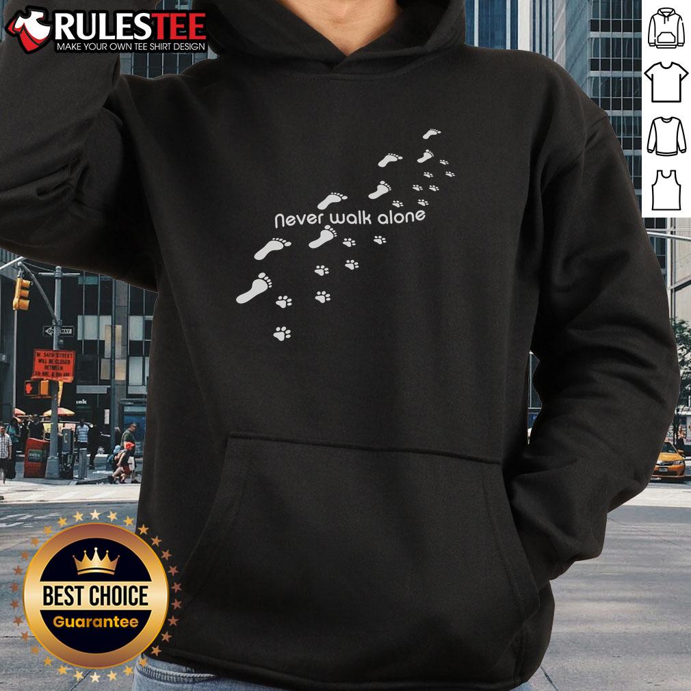 Alt Text: Cute dog owner wearing a 'Never Walk Alone' hoodie with dog paw print, showcasing love for pets and companionship.