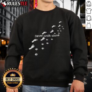 Alt Text: Cute dog owner wearing a 'Never Walk Alone' sweatshirt with dog paw print, showcasing love for pets and stylish comfort.