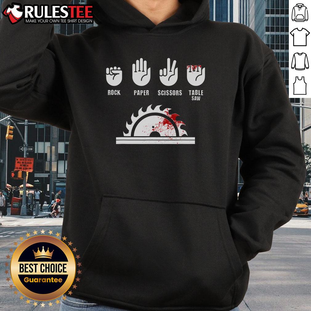 Funny carpenter playing rock-paper-scissors with a table saw, wearing a humorous hoodie for woodworking enthusiasts.