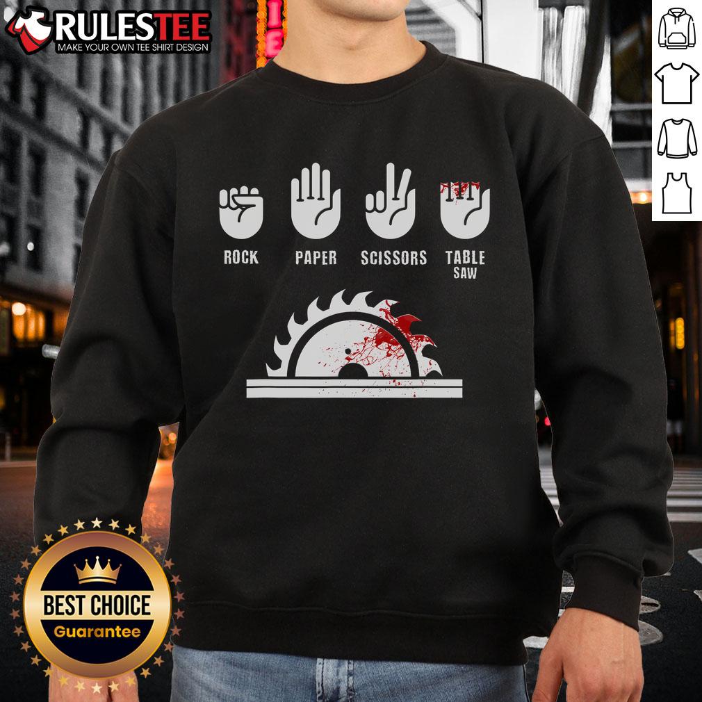 Alt Text: Funny carpenter playing rock-paper-scissors with a table saw on a sweatshirt design, perfect for woodworking enthusiasts.