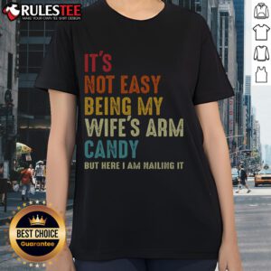 Funny ladies tee: 'It's Not Easy Being My Wife's Arm Candy' showcasing a stylish design perfect for casual wear.