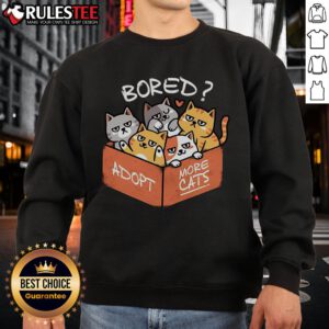 Cute bored cat wearing a sweatshirt that says 'Adopt More Cats' promoting cat adoption and awareness.