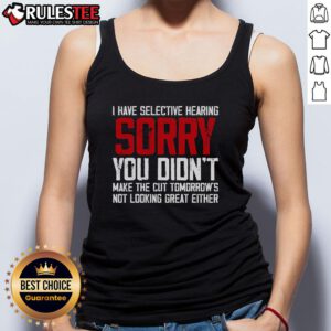 Funny cat showcasing selective hearing while wearing a tank top, humorously ignoring its owners call.