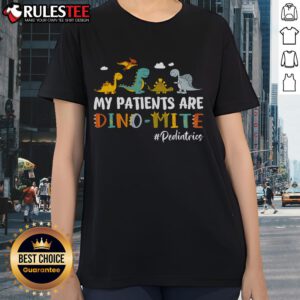 Alt Text: Cute pediatric nurse wearing 'My Patients Are Dino-Mite' tee featuring colorful dinosaurs, perfect for kids' healthcare.