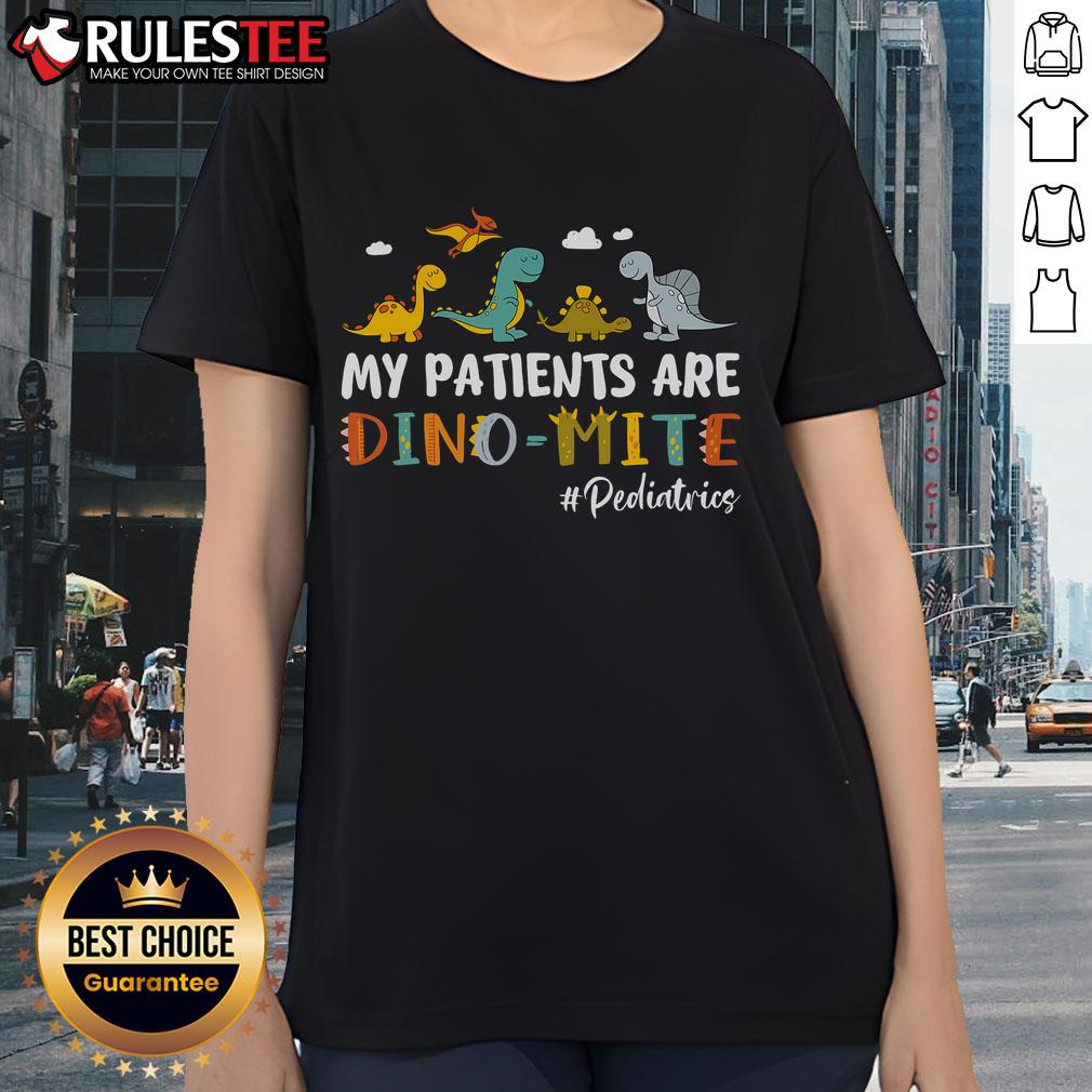 Alt Text: Cute pediatric nurse wearing 'My Patients Are Dino-Mite' tee featuring colorful dinosaurs, perfect for kids' healthcare.