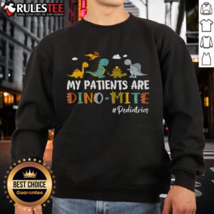 Pediatric nurse wearing a 'My Patients Are Dino-Mite' dinosaur sweatshirt, showcasing fun and playful healthcare vibe.