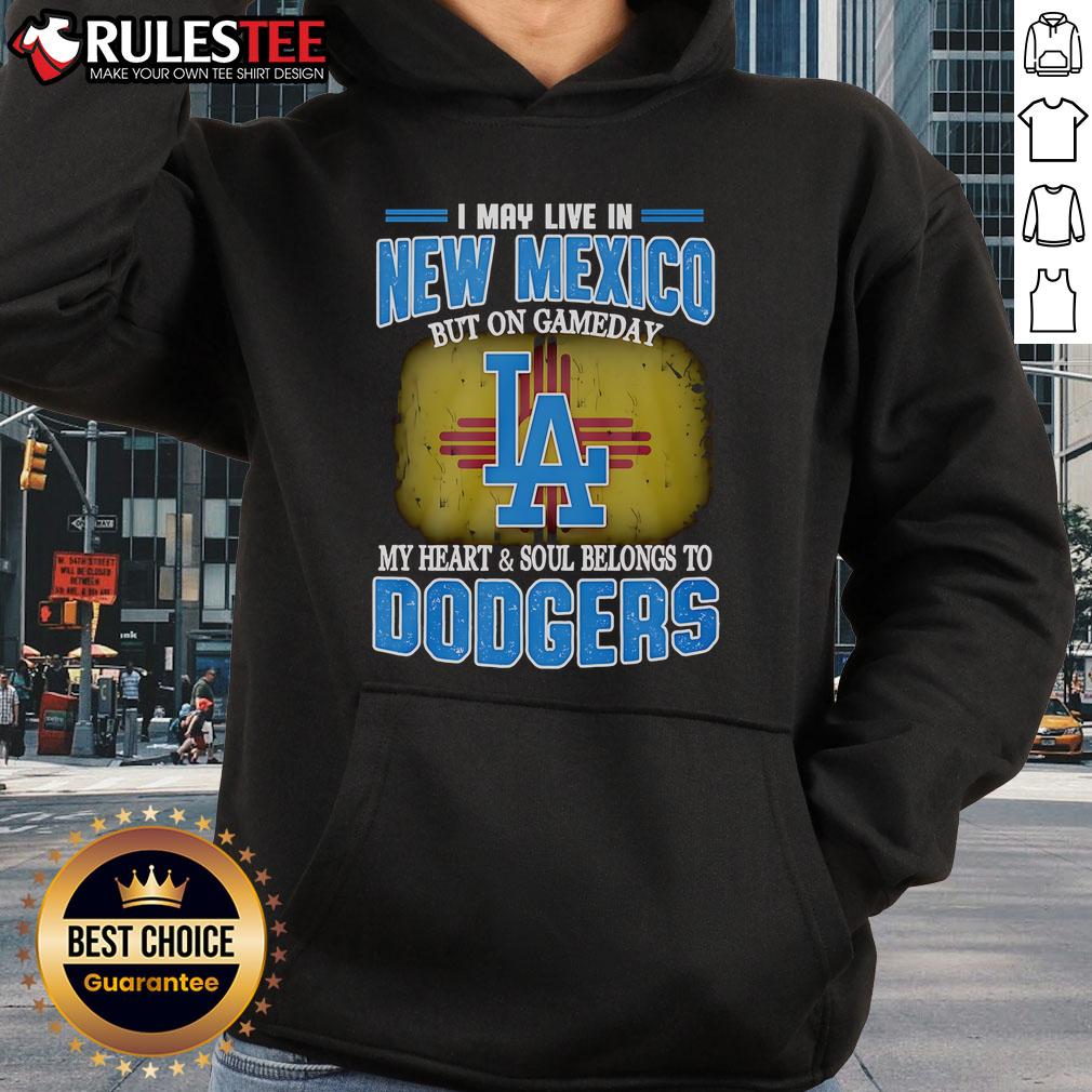 Person wearing a Dodgers hoodie in New Mexico, showcasing team spirit on game day with a vibrant backdrop.