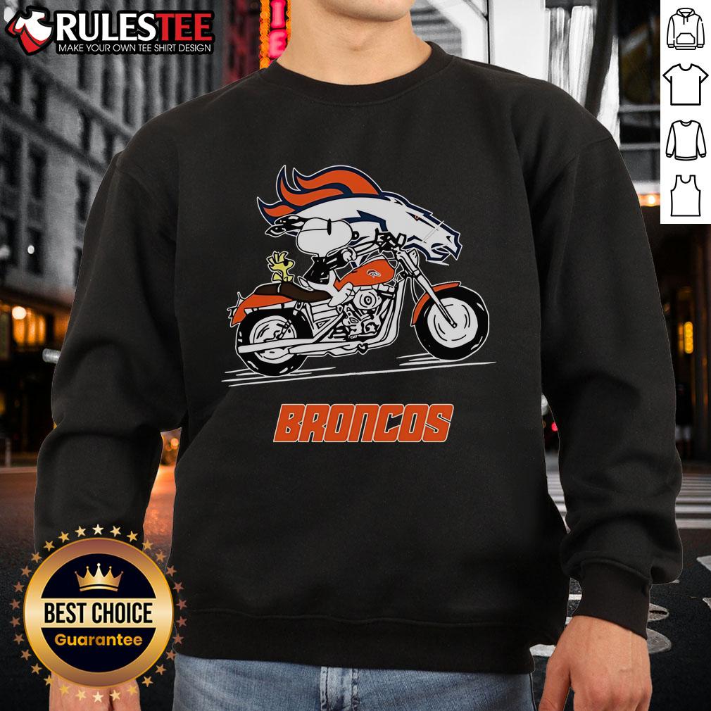 Alt Text: Snoopy and Woodstock riding a motorbike in a Denver Broncos sweatshirt, showcasing a fun and stylish design.