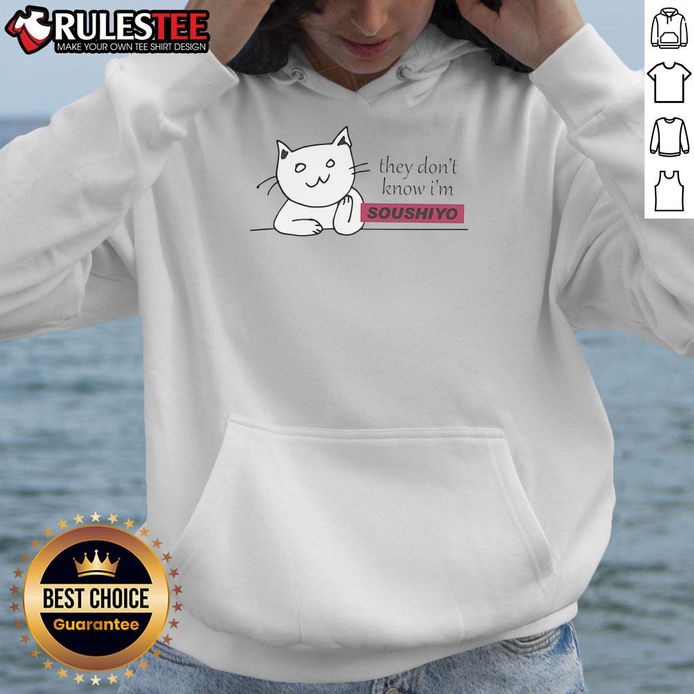 Alt Text: Cute cat wearing a Soushiyo hoodie, showcasing playful style and charm in a cozy indoor setting.
