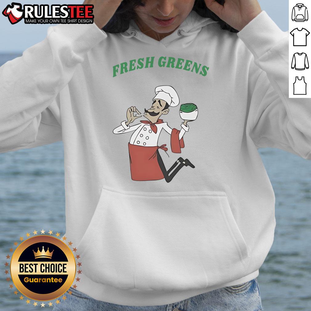 Chef wearing Awesome Fresh Greens Hoodie in a vibrant kitchen, showcasing culinary creativity and fresh ingredients.