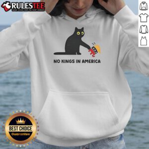Alt Text: Cute black cat wearing a 'No Kings in America' hoodie with an elephant, symbolizing playful political satire.