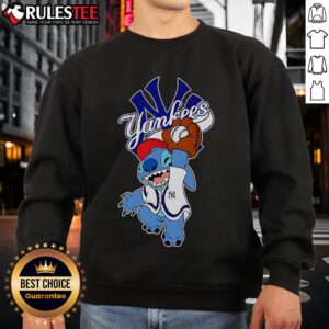 Alt Text: Cute Stitch wearing a New York Yankees sweatshirt while playing baseball, showcasing a fun sports vibe.