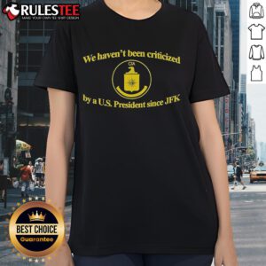Funny CIA t-shirt depicting 'We Haven't Been Criticized By A US President Since JFK' for ladies, showcasing humor and history.