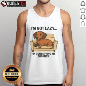 Funny dog wearing a tank top that says I'm not lazy, I'm conserving my zoomies showcases humor and pet fashion.