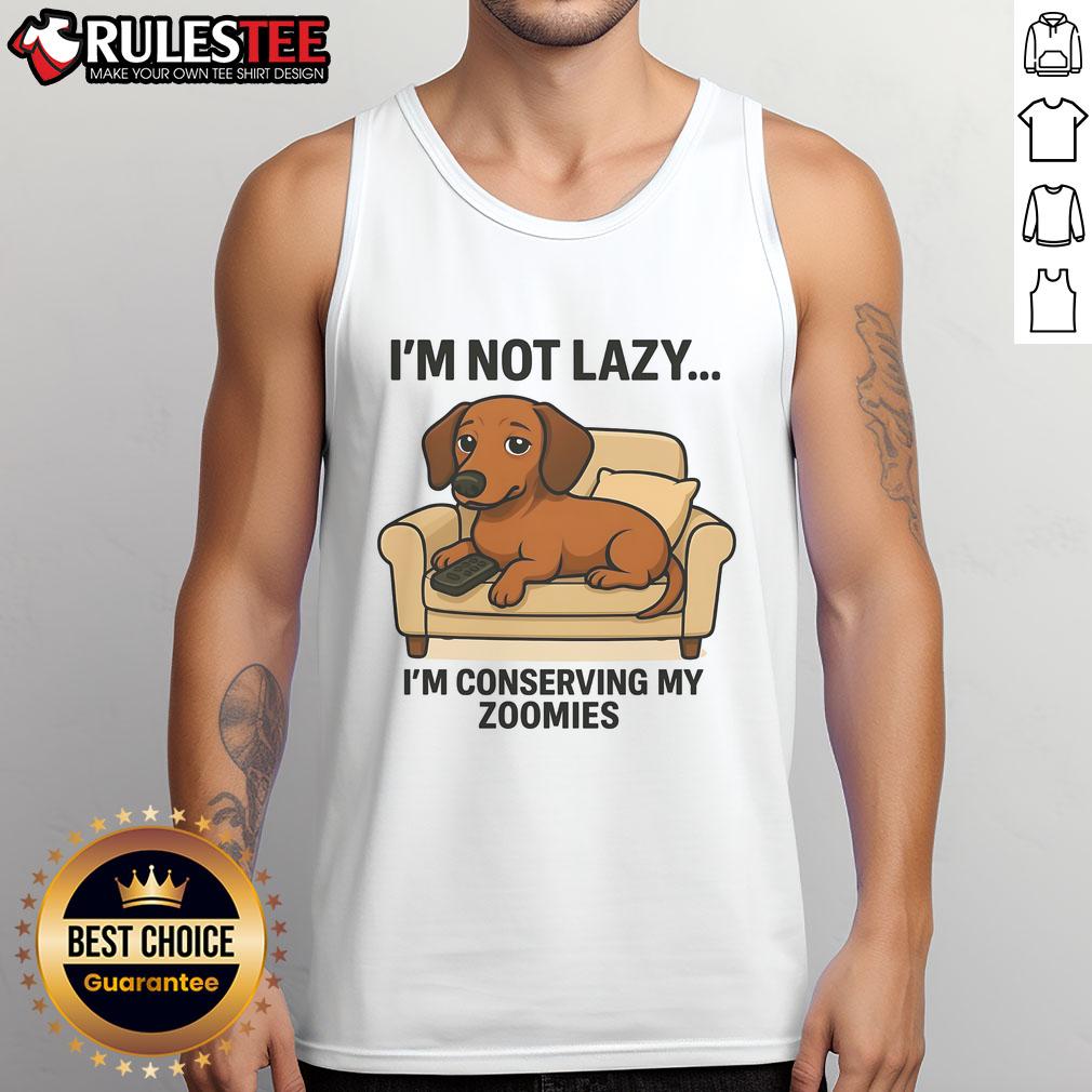 Funny dog wearing a tank top that says I'm not lazy, I'm conserving my zoomies showcases humor and pet fashion.