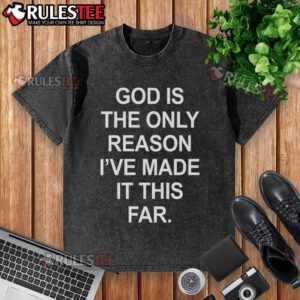 Alt Text: Official God Is The Only Reason I've Made It This Far washed t-shirt displayed on a hanger, showcasing its design.