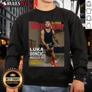 Luka Doncic flexes muscles in a Lakers-themed sweatshirt during summer training, showcasing strength and style.