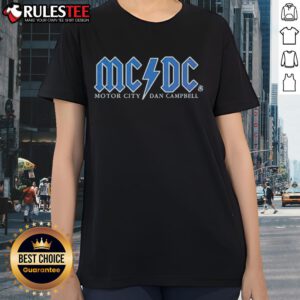 Alt Text: Good Detroit Lions Football Motor City Dan Campbell Ladies Tee featuring team colors and logo design.