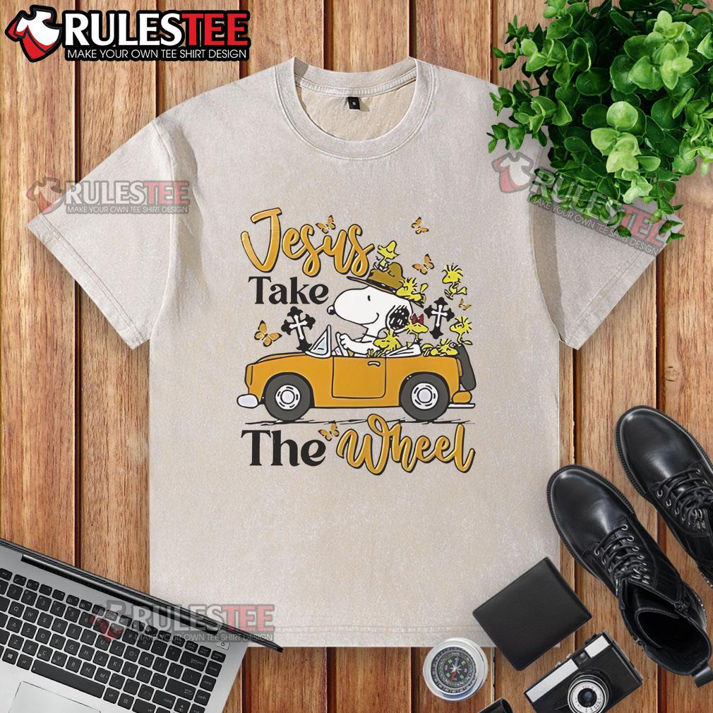 Alt Text: Nice Snoopy Jesus Take The Wheel washed t-shirt featuring a playful Snoopy graphic and inspirational text.