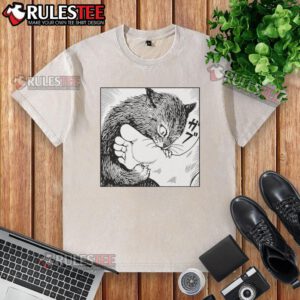 Alt Text: Cartoon design of a cat playfully biting feet on a premium washed t-shirt, perfect for cat lovers and casual wear.
