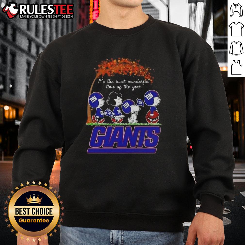 Alt Text: Cozy New York Giants football sweatshirt featuring It's The Most Wonderful Time Of The Year with awesome peanuts design.