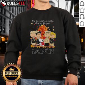 Awesome Peanuts character sweatshirt featuring New Orleans Saints theme, perfect for the holiday season.
