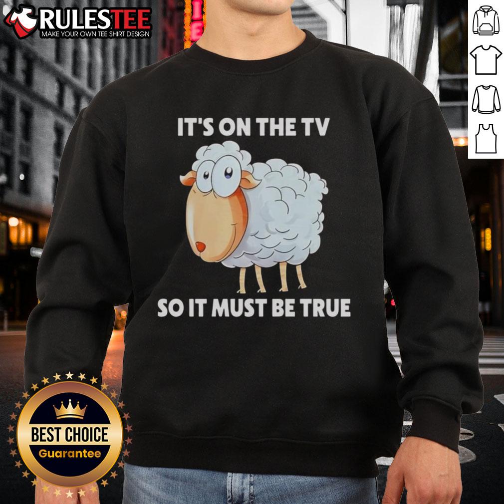 Funny sheep sweatshirt featuring 'It's on the TV, so it must be true' design, perfect for humorous apparel lovers.