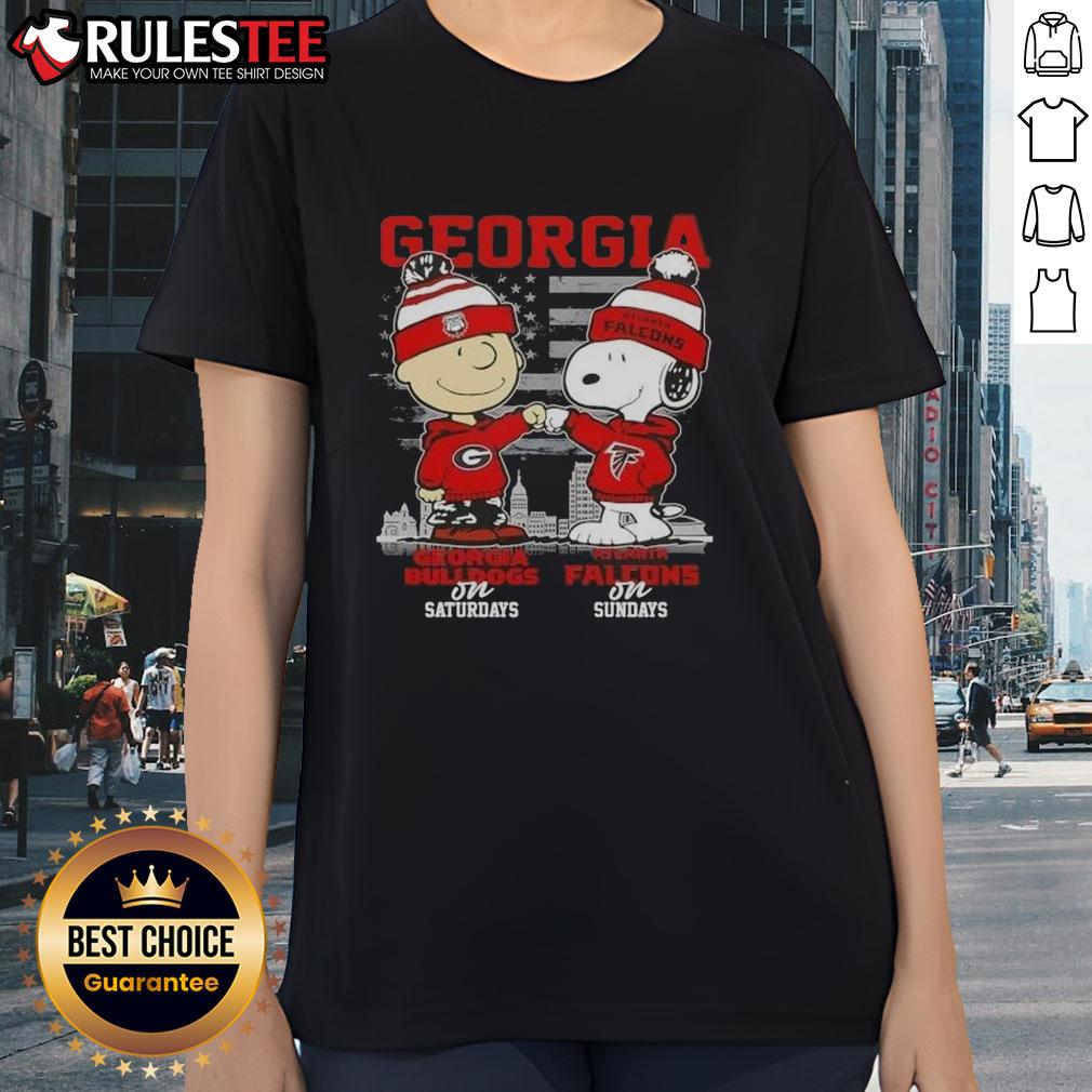Alt Text: Good Charlie Brown Georgia Bulldogs Saturdays x Snoopy Atlanta Falcons Sundays Skyline Ladies Tee design.
