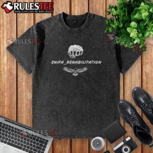 Alt Text: Good Tony Ferguson Shifa Rehabilitation washed t-shirt displayed on a hanger, showcasing its unique design and comfort.