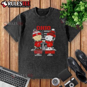 Happy Charlie Brown in Ohio State Buckeyes tee and Snoopy in Cleveland Browns shirt against a skyline backdrop.