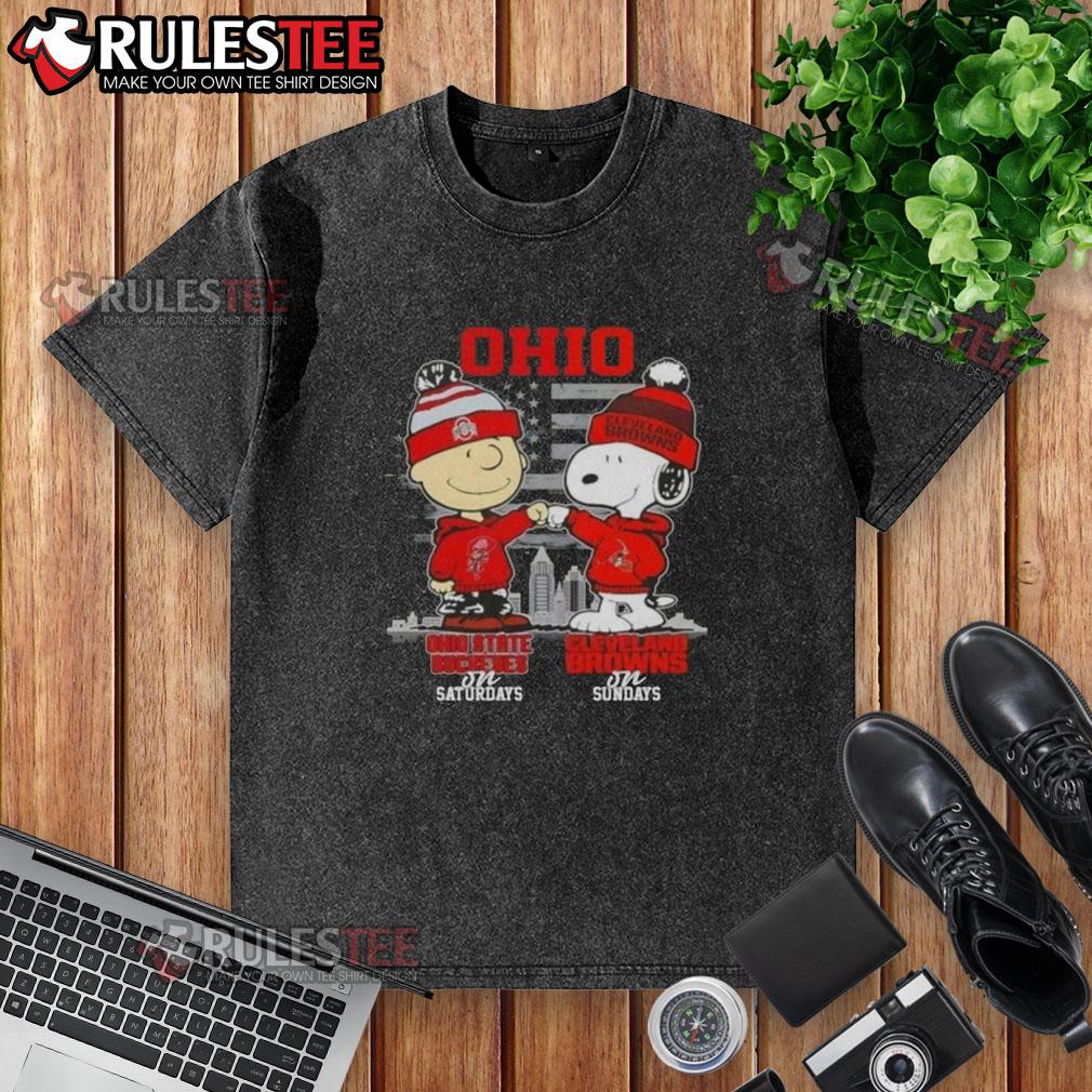 Happy Charlie Brown in Ohio State Buckeyes tee and Snoopy in Cleveland Browns shirt against a skyline backdrop.