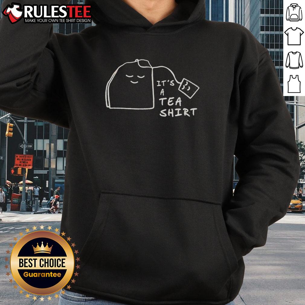 Official 'It's A Tea' hoodie displayed on a rustic wooden table, showcasing its stylish design and vibrant colors.